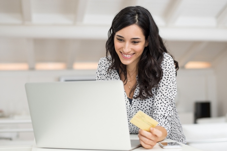 Woman paying bill online with laptop.